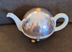New Pamono Vintage Art Deco German Cream-white Porcelain Spherical Teapot with Silver-Plated Thermal Jacket and Yellow-Brown Bakelite Feet from WMF, 1940s